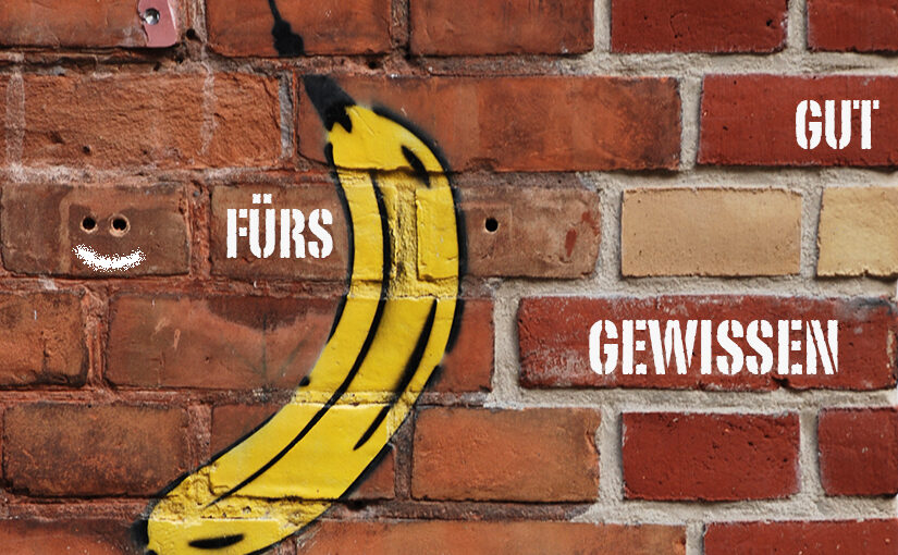 Veebs App Analogie: Eine Backsteinwand mit einem Grafitto, das eine Banane darstellt und dazu der Spruch - Gut fürs Gewissen